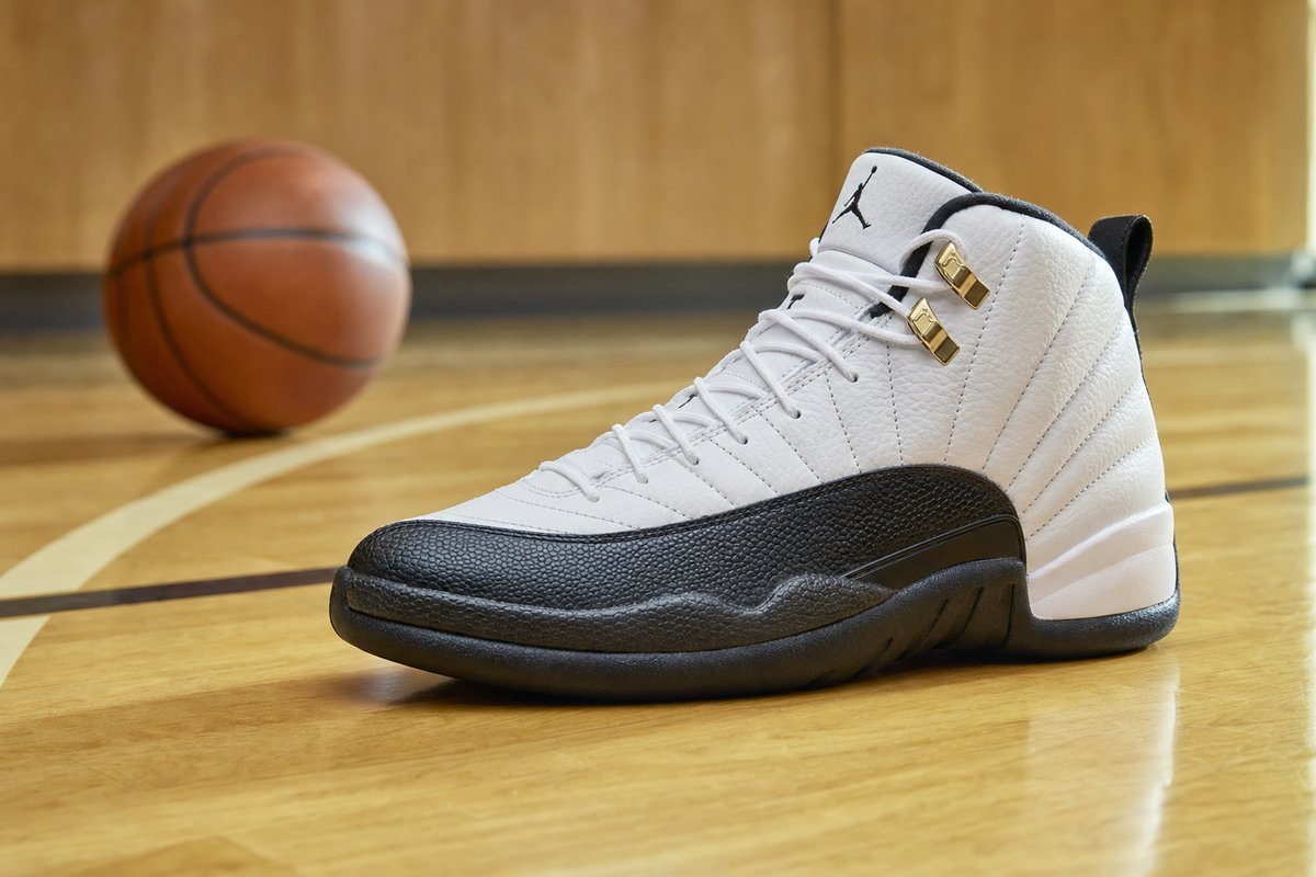 Athletic basketball sneakers with high ankle support on gym floor with basketball in background